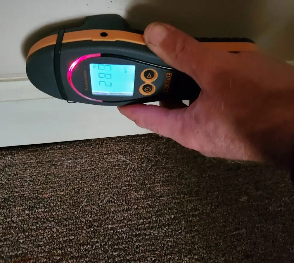 Moisture detection at baseboard during Storm Damage Restoration in Richmond Heights